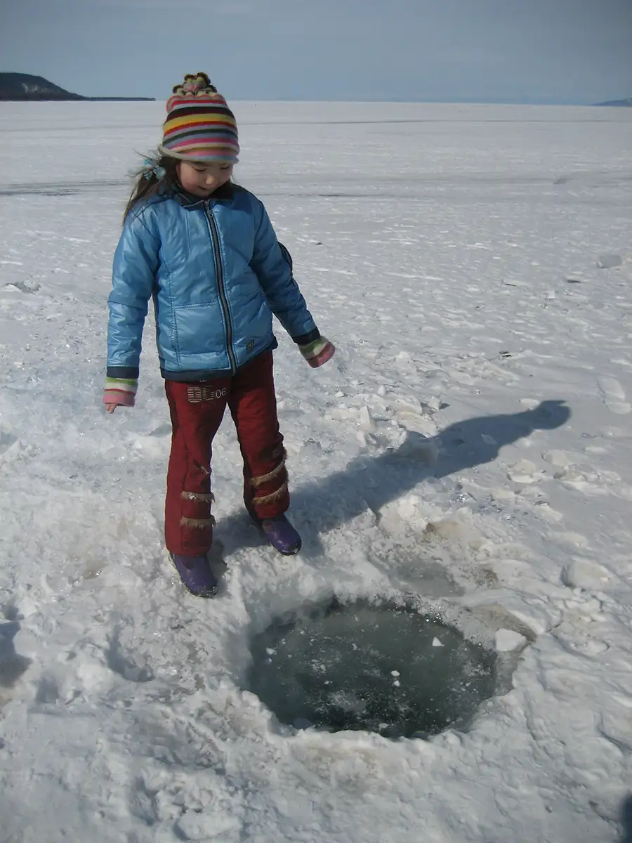mongolia kid, playing on ice sea, 