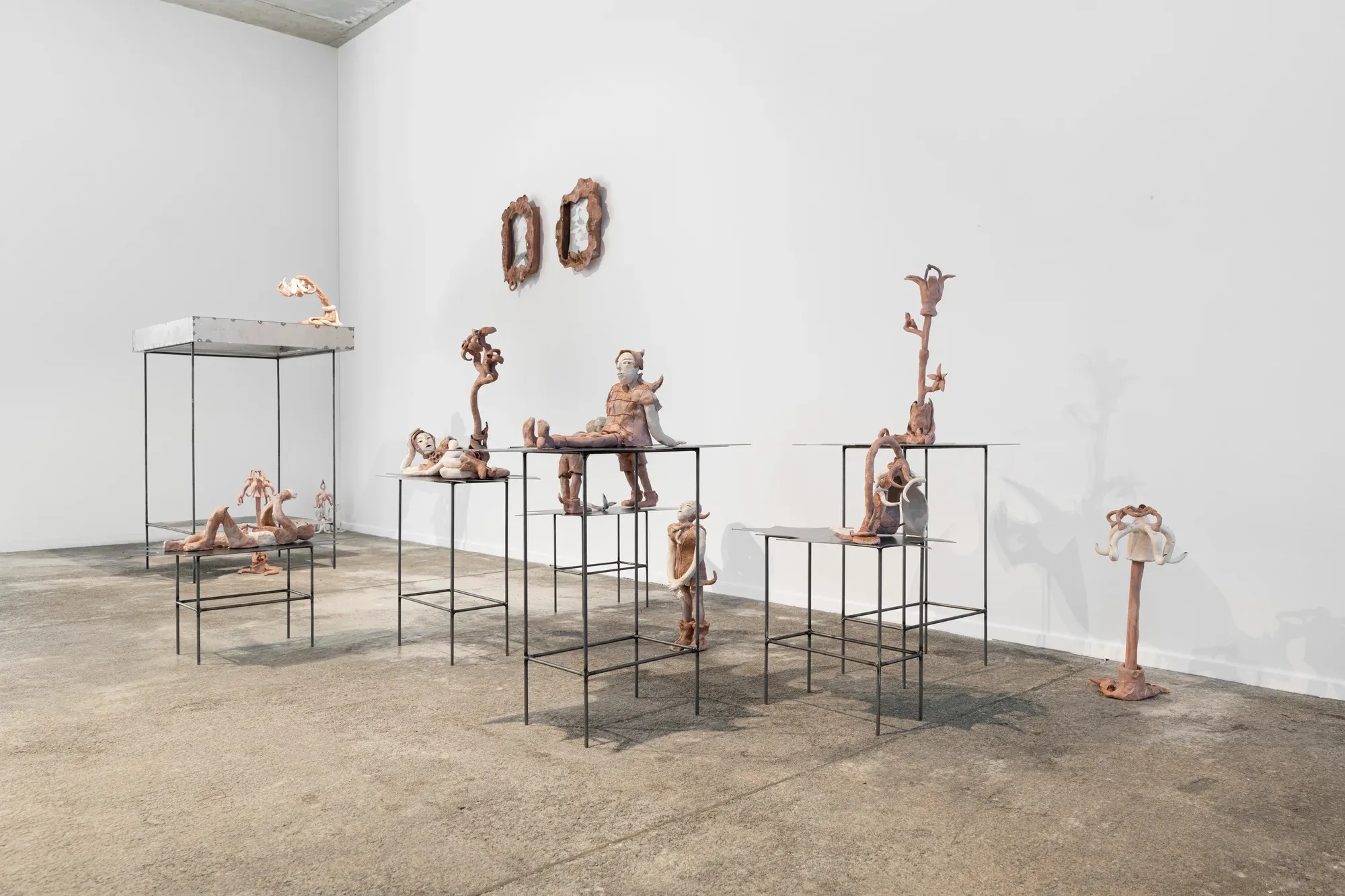 anna bochkova's sculptural installation at tomas umrian contemporary featuring figures on metal tables